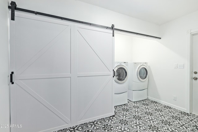 6628 N 2nd Ave, Phoenix, AZ 85013 - washroom featuring a barn door, washer and clothes dryer, and baseboards