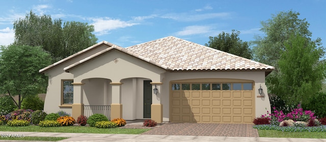 view of front of house featuring stucco siding, decorative driveway, a tiled roof, and a garage