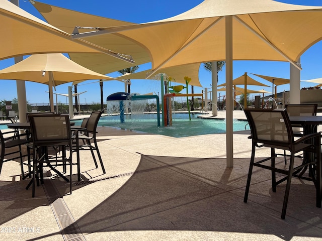 view of patio / terrace featuring pool water feature and a community pool