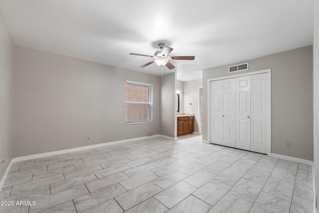 unfurnished bedroom featuring a closet and ceiling fan