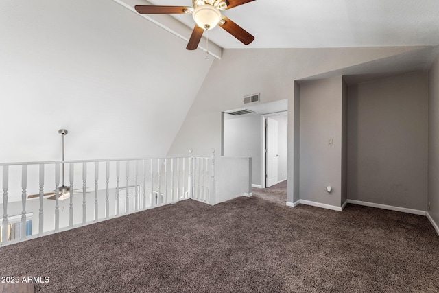 carpeted empty room featuring ceiling fan and vaulted ceiling with beams