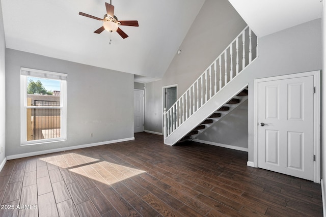 unfurnished living room with ceiling fan, dark hardwood / wood-style floors, and high vaulted ceiling