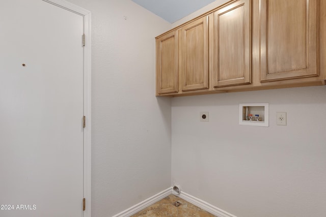 clothes washing area with hookup for an electric dryer, cabinets, and washer hookup