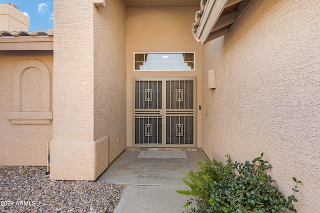 doorway to property featuring stucco siding