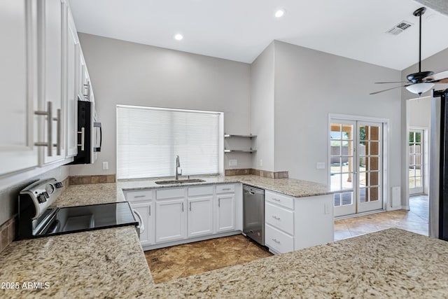 kitchen featuring white cabinetry, visible vents, stainless steel appliances, and a sink