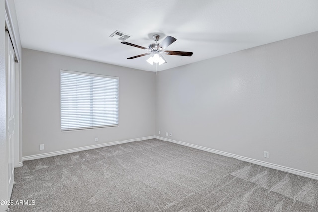 unfurnished room featuring baseboards, ceiling fan, visible vents, and carpet flooring