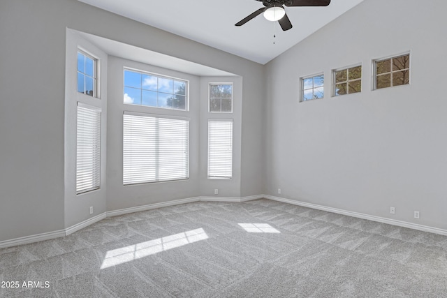 carpeted spare room with high vaulted ceiling, a healthy amount of sunlight, ceiling fan, and baseboards