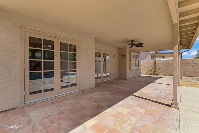 view of patio featuring french doors, fence, and a ceiling fan