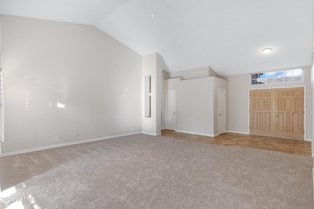 interior space with high vaulted ceiling, baseboards, and carpet flooring