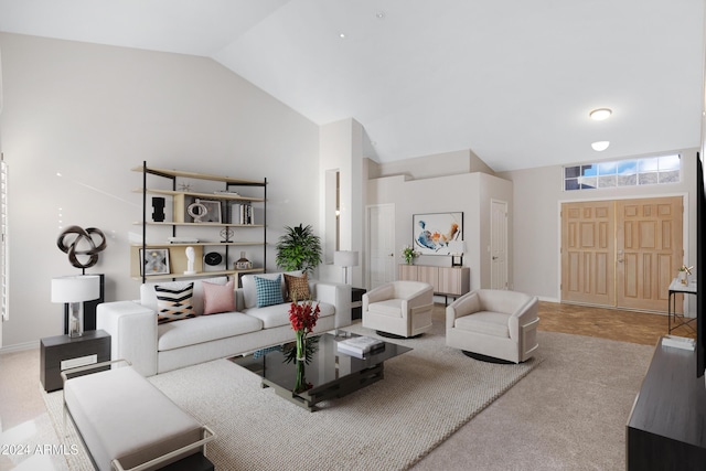 living room with high vaulted ceiling and baseboards