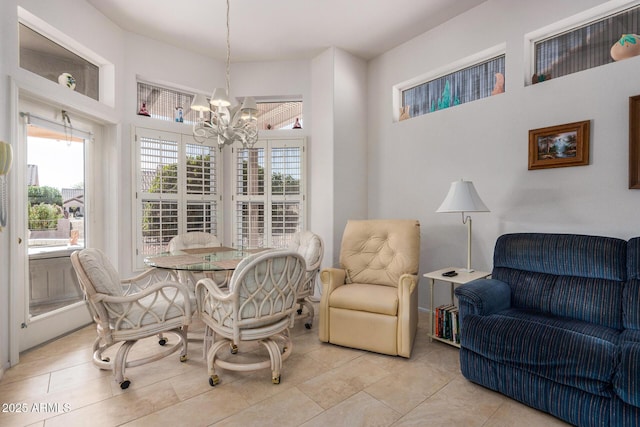 dining area featuring light tile patterned floors and a notable chandelier