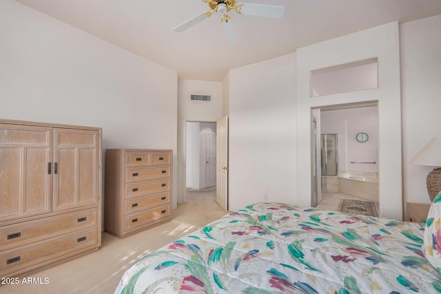 bedroom featuring ceiling fan, ensuite bathroom, and light carpet