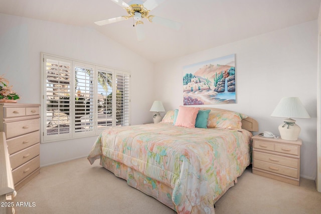 carpeted bedroom featuring ceiling fan and vaulted ceiling