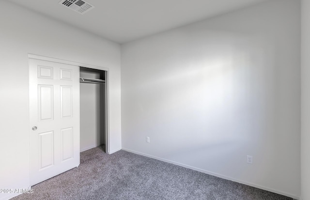 unfurnished bedroom featuring a closet and carpet flooring