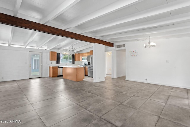 unfurnished living room with baseboards, visible vents, lofted ceiling with beams, a sink, and a chandelier