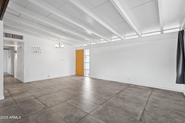 unfurnished room with beam ceiling, a notable chandelier, baseboards, and visible vents