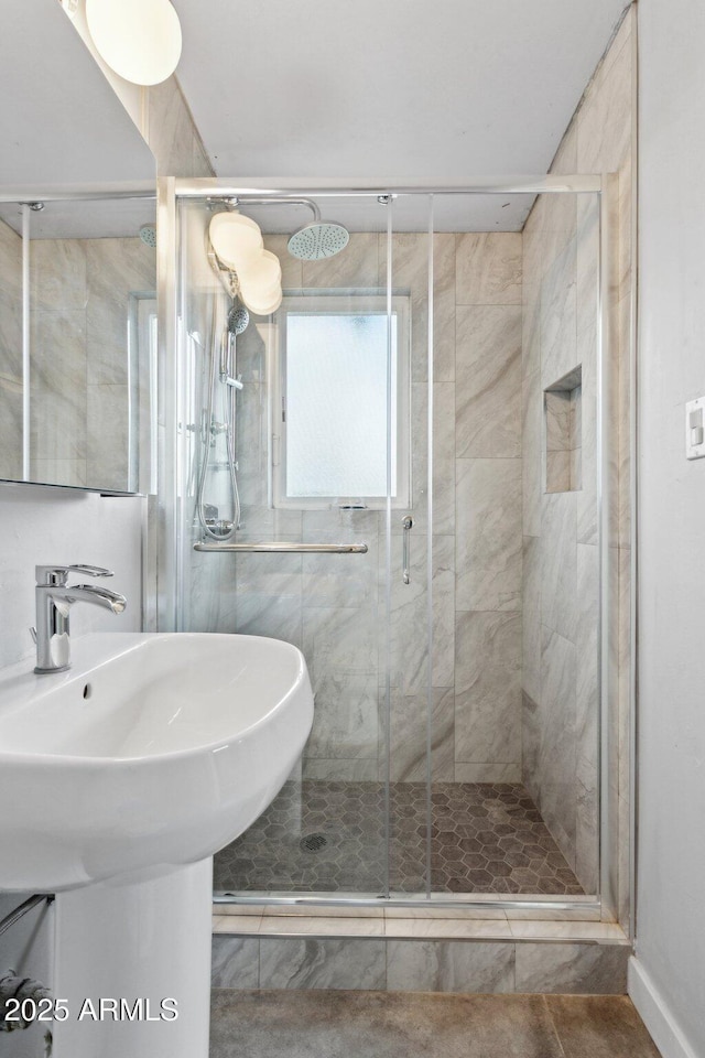 full bathroom with a stall shower and tile patterned flooring