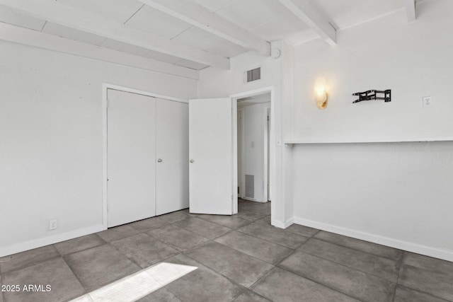 interior space featuring visible vents, baseboards, and beamed ceiling