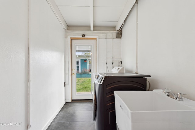 laundry area featuring laundry area, washer / dryer, and a sink