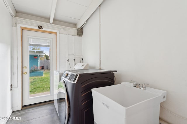 laundry room with a sink, washer / clothes dryer, and laundry area