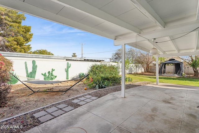 view of patio featuring a gazebo and a fenced backyard