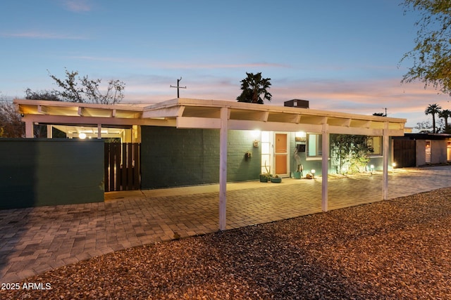 view of front of house featuring a gate, a patio, and fence