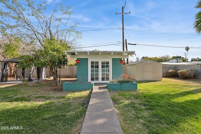 view of front of house with an outbuilding, french doors, a gazebo, and fence