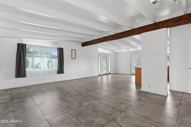 unfurnished living room with vaulted ceiling with beams