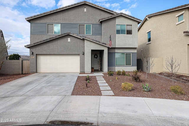 traditional-style home with a tiled roof, stucco siding, driveway, and fence