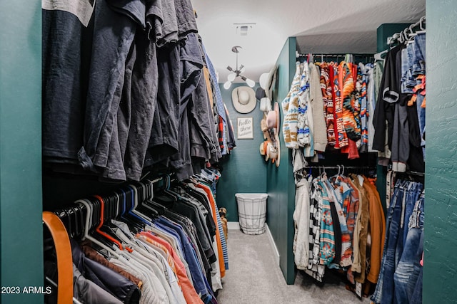 walk in closet with carpet floors and visible vents