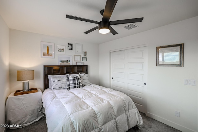 carpeted bedroom with baseboards, ceiling fan, a closet, and visible vents