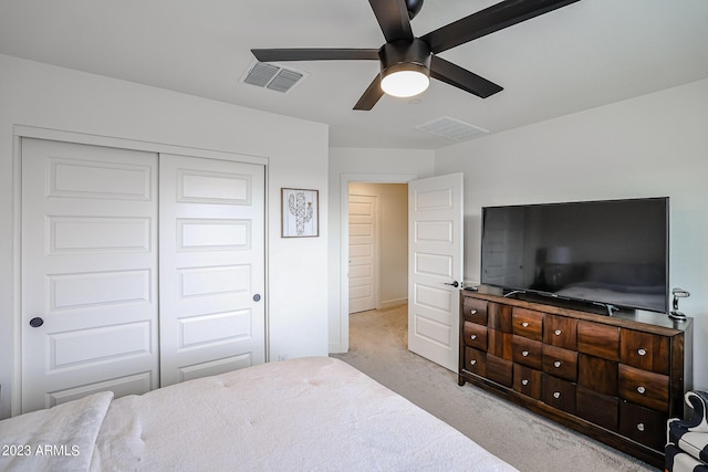 carpeted bedroom featuring baseboards, a ceiling fan, a closet, and visible vents
