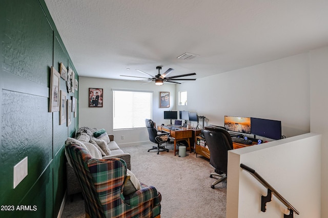 carpeted office featuring ceiling fan, visible vents, and baseboards