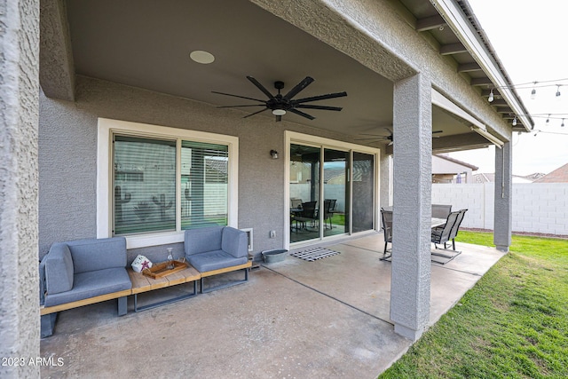 view of patio with an outdoor living space, ceiling fan, and fence