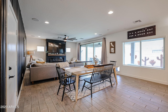 dining space featuring ceiling fan, visible vents, baseboards, light wood-style floors, and recessed lighting
