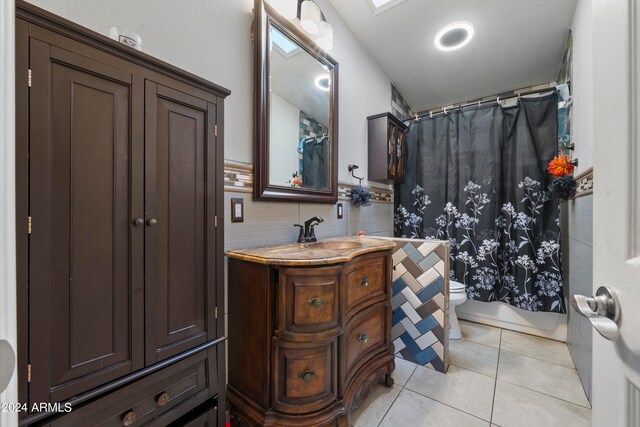 full bathroom with toilet, tile patterned flooring, vanity, decorative backsplash, and shower / tub combo