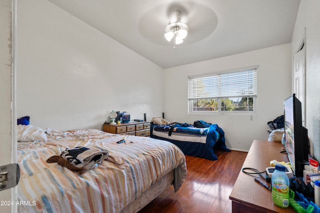 bedroom with dark wood-type flooring, ceiling fan, and vaulted ceiling