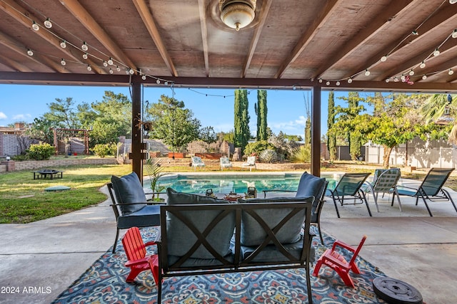 view of patio / terrace with a fenced in pool and an outdoor fire pit