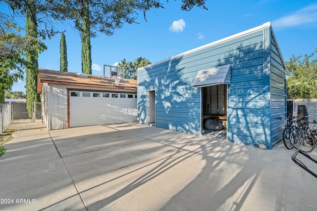 contemporary home featuring an outdoor structure and a garage