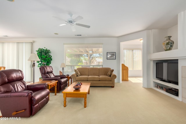 living room with light colored carpet and ceiling fan