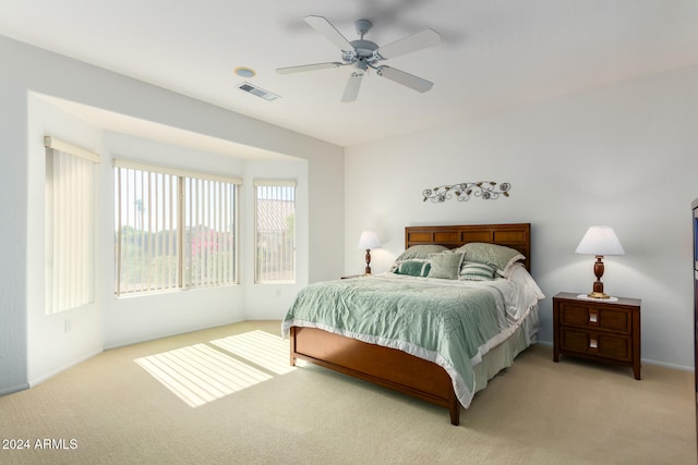 bedroom with ceiling fan and light colored carpet