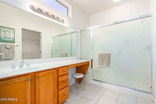 bathroom featuring vanity, tile patterned flooring, and a shower with door