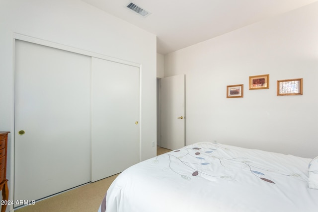 carpeted bedroom with a closet