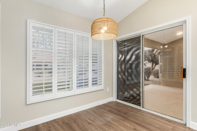 unfurnished room featuring hardwood / wood-style flooring and vaulted ceiling