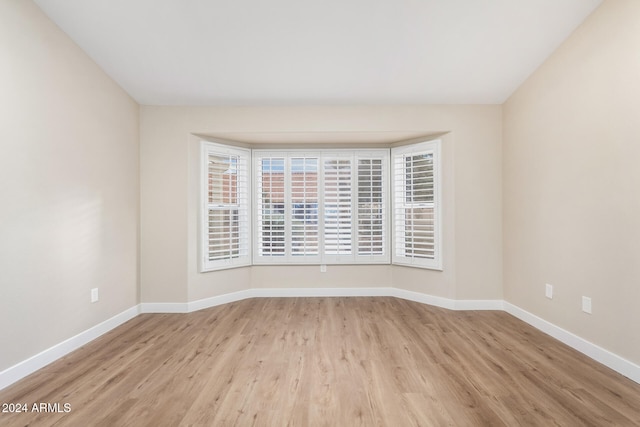 unfurnished room with light hardwood / wood-style floors