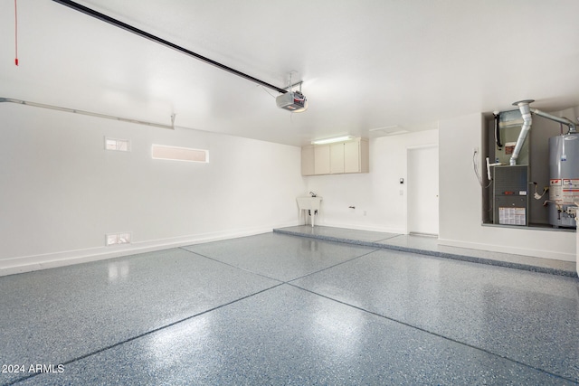 garage featuring sink, water heater, heating unit, and a garage door opener