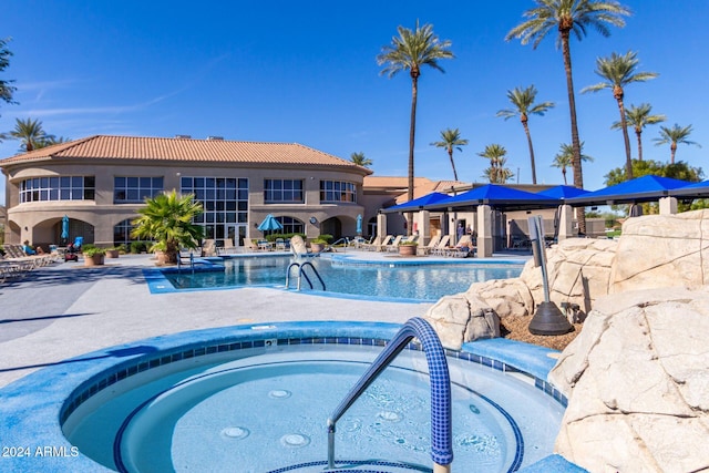 view of swimming pool featuring a patio and a community hot tub