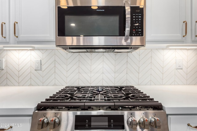 kitchen featuring white cabinetry, stainless steel appliances, and decorative backsplash