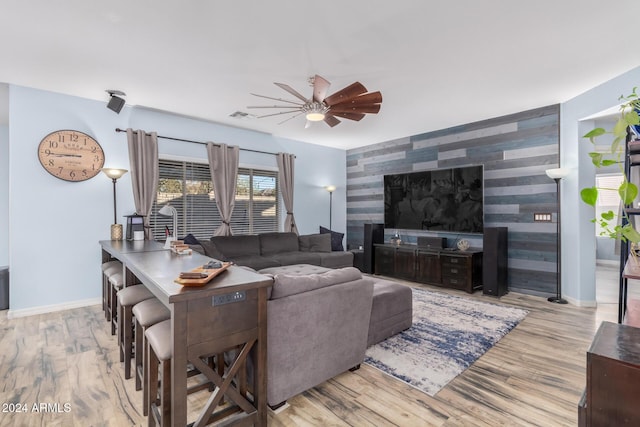 living room with ceiling fan and light hardwood / wood-style floors