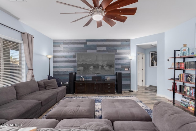 living room with ceiling fan and light wood-type flooring